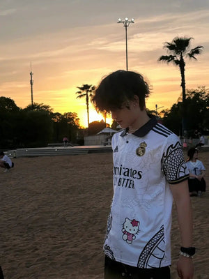 Show off your love for Real Madrid and Hello Kitty with our Dragon Jersey! Made with high-quality materials for maximum comfort and durability. Perfect for any fan or collector, this jersey showcases unique design elements that make it truly one-of-a-kind