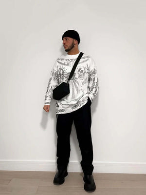 Add rebellious flair to your wardrobe with the Skull Print Distressed Sweater — a bold piece that fuses comfort with urban attitude. Crafted from a soft cotton blend, this long-sleeve sweater features a striking skull and crossbones graphic, ribbed cuffs