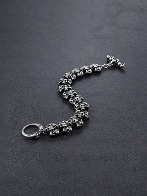 Antiqued Skull Link Biker Bracelet – laid open flat on dark surface | XoKool