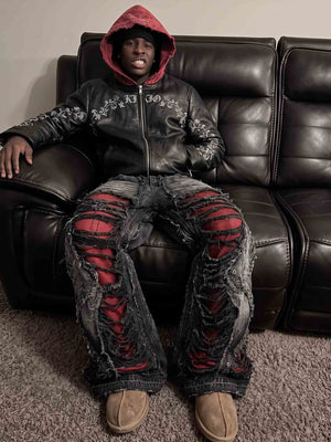 Black Shredded Jeans – lifestyle, seated on sofa | XoKool