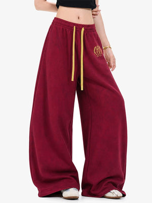 Burgundy Sweatpants with Back Arch Graphic – on model, Red front | XoKool