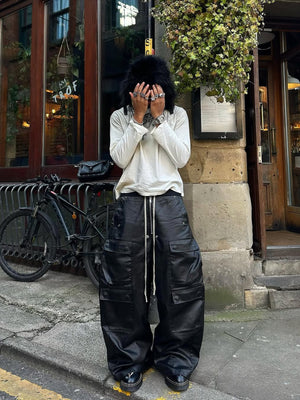 Coated Black Wide Leg Cargo Pants – Street photo, model covering face | XoKool