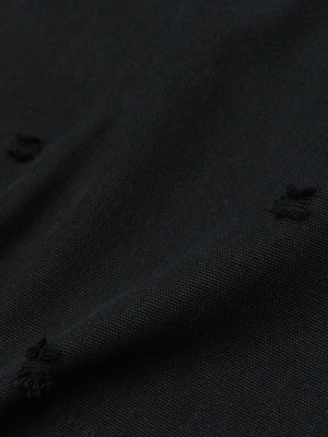 Black rugby shirt – distressed holes close-up | XoKool