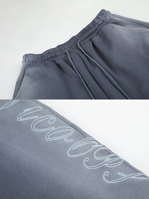 Faded sweatpants – Waistband and script print close-up | XoKool