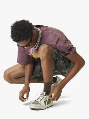 Tree camo cargo shorts – on model, crouching | XoKool