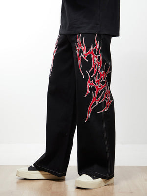 Black Baggy Jeans with Red Flame Embroidery – On model, side | XoKool