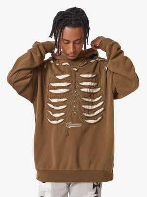 Washed Brown Skeleton Hoodie with Rib Cage Applique – on model, front, hands at hood | XoKool
