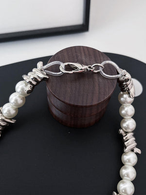 Pearl Choker with Barbed Wire Twists – clasp close-up on wood stand | XoKool