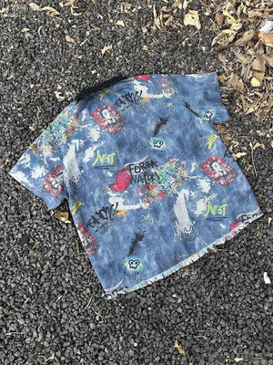 Graffiti denim shirt – flat lay on gravel | XoKool