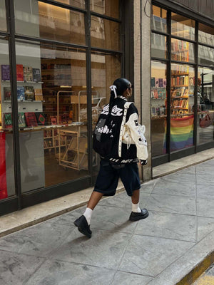 Black and White Varsity Jacket with Chenille Patches – street photo, walking | XoKool