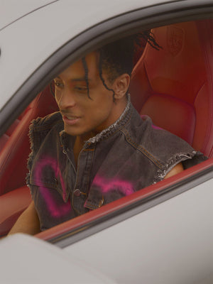 Spray Paint Heart Denim Vest – Washed Black, on model in car | XoKool