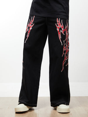 Black Baggy Jeans with Red Flame Embroidery – On model, front | XoKool