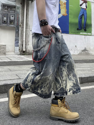 Long Baggy Jorts with Bleached Flame Wash – on model, side, street | XoKool