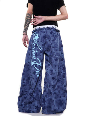 Star sweatpants – Blue, on model front with script | XoKool