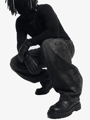 Washed black barrel jeans – on model, crouching | XoKool