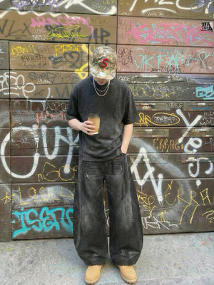 Washed Black Barrel Jeans with Sandblast Fade – street photo, front, graffiti wall | XoKool