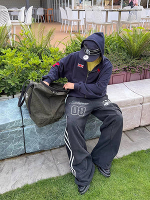 Washed Black Side Stripe Varsity Sweatpants – On model, sitting | XoKool