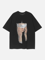 Black t-shirt with a graphic of hands covering a face on a white background