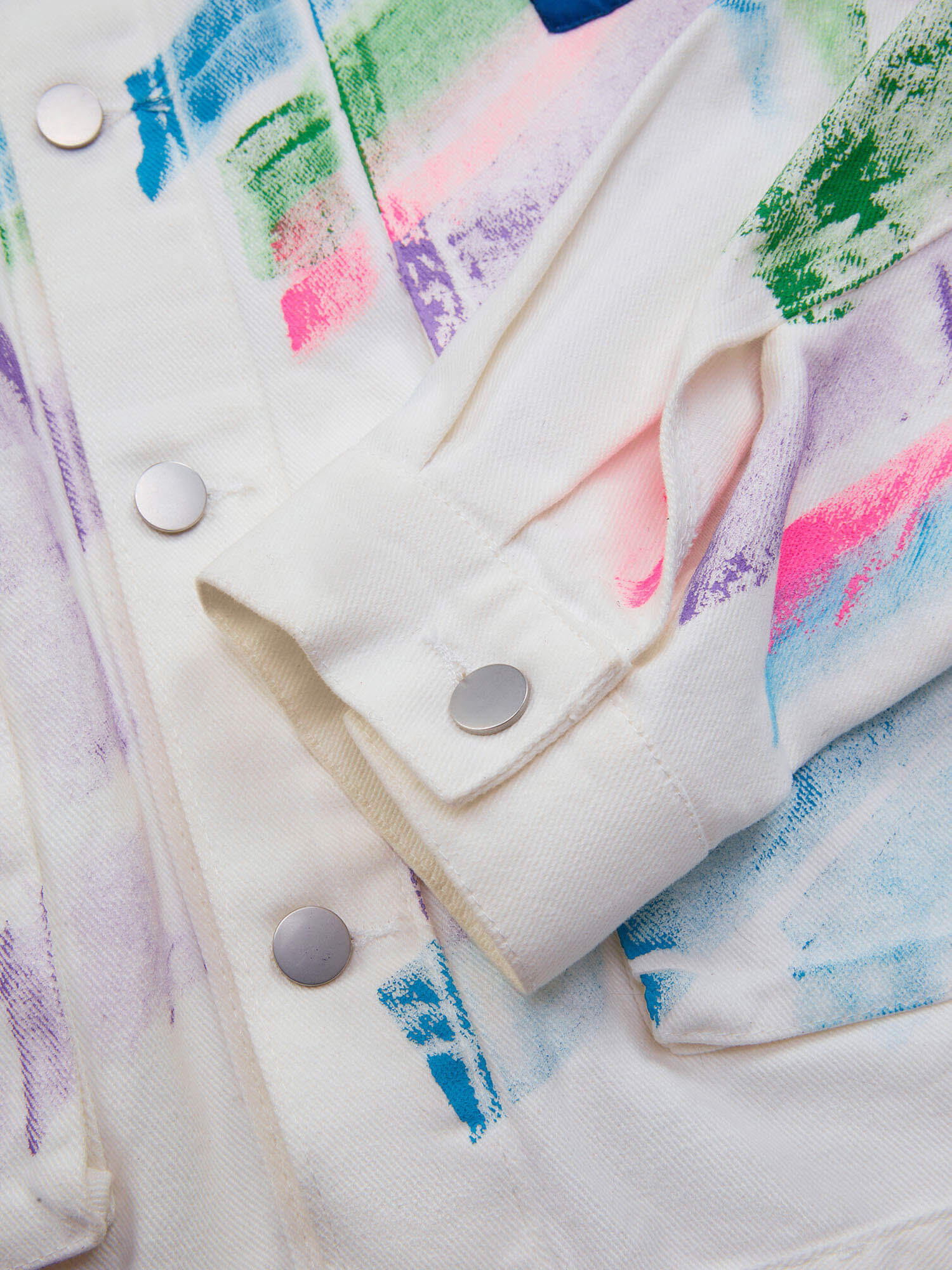 Express your individuality with the Hip Hop Hand Painted Graffiti Denim Jacket. Made from high-quality polyester with a smooth satin finish, this bold jacket features an all-over abstract graffiti print in vibrant neon colors that instantly grabs attentio