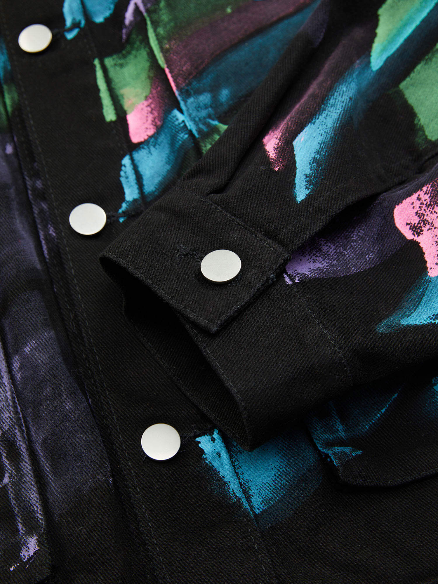 Express your individuality with the Hip Hop Hand Painted Graffiti Denim Jacket. Made from high-quality polyester with a smooth satin finish, this bold jacket features an all-over abstract graffiti print in vibrant neon colors that instantly grabs attentio