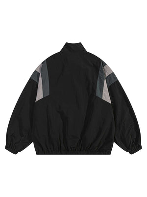Step out in bold confidence with the Patchwork Contrasting Windbreaker Jacket — a lightweight statement piece inspired by retro athletic wear. Made from durable polyester, this jacket features a dynamic color-block pattern with contrast panels, a branded