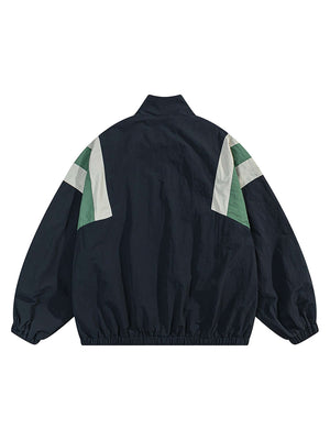 Step out in bold confidence with the Patchwork Contrasting Windbreaker Jacket — a lightweight statement piece inspired by retro athletic wear. Made from durable polyester, this jacket features a dynamic color-block pattern with contrast panels, a branded
