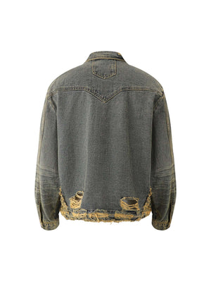 Turn heads with the Raw Edge Distressed Denim Jacket — a bold streetwear essential combining rugged denim with statement gold chain detailing. This long-sleeve jacket features raw hems, distressed accents, and front chest pockets with button closure for a