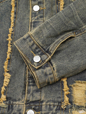 Turn heads with the Raw Edge Distressed Denim Jacket — a bold streetwear essential combining rugged denim with statement gold chain detailing. This long-sleeve jacket features raw hems, distressed accents, and front chest pockets with button closure for a