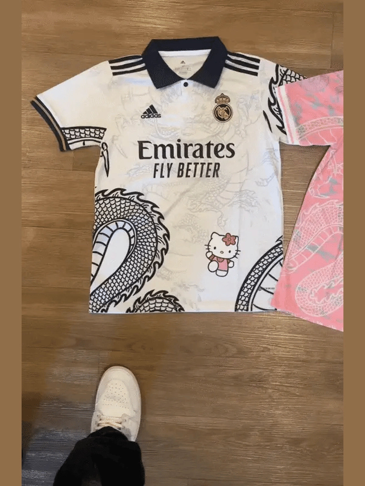 Show off your love for Real Madrid and Hello Kitty with our Dragon Jersey! Made with high-quality materials for maximum comfort and durability. Perfect for any fan or collector, this jersey showcases unique design elements that make it truly one-of-a-kind