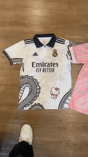Show off your love for Real Madrid and Hello Kitty with our Dragon Jersey! Made with high-quality materials for maximum comfort and durability. Perfect for any fan or collector, this jersey showcases unique design elements that make it truly one-of-a-kind