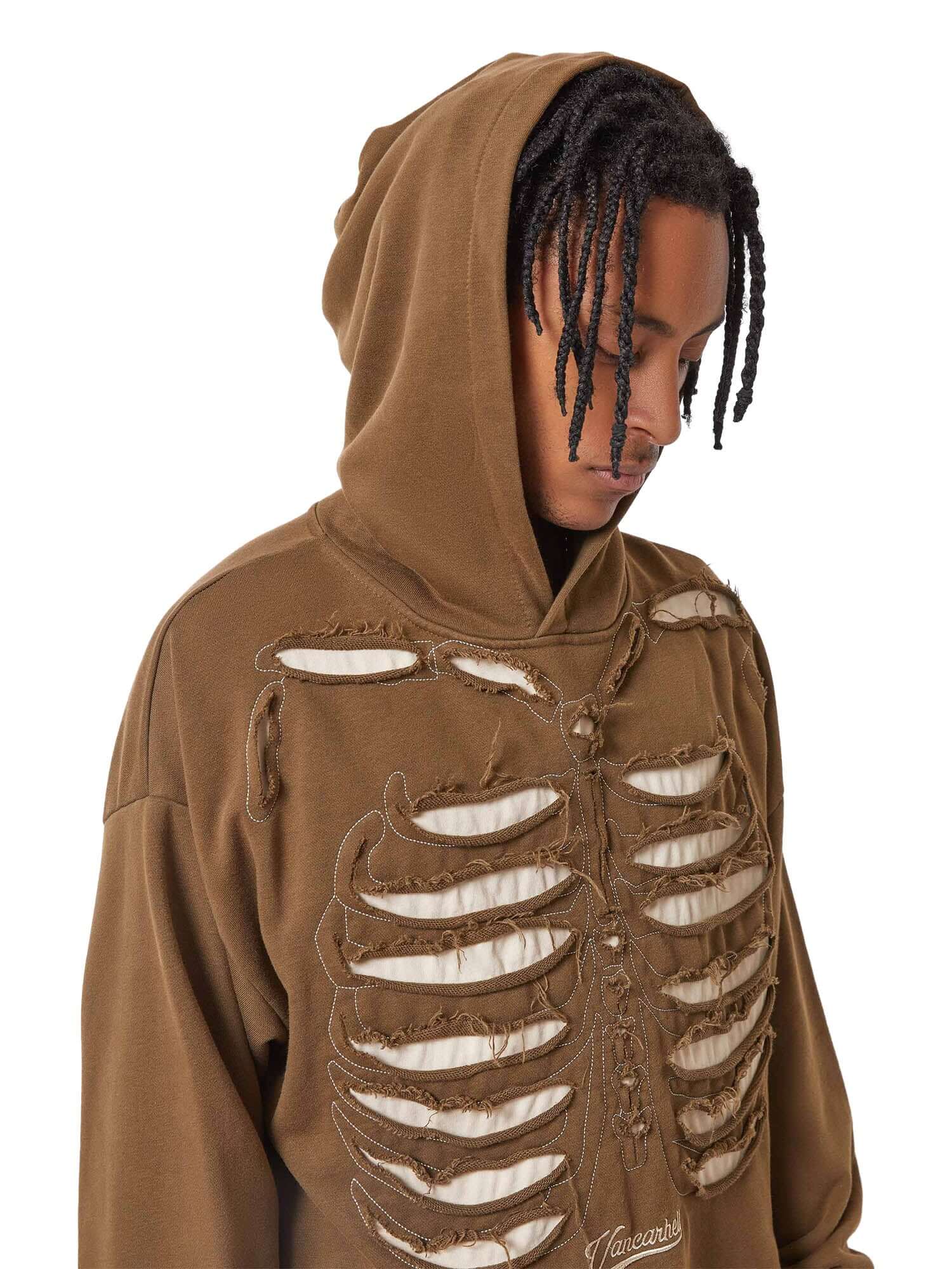 Make a bold statement with the Washed And Aged Hooded Sweatshirt — a cozy, oversized piece featuring a striking rib cage design. Crafted from a soft cotton blend, this hoodie blends comfort and attitude with its spooky, skeleton-inspired graphic. Perfect