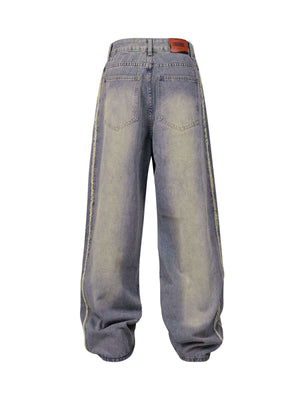 Upgrade your streetwear look with the Washed Distressed Raw Edge Baggy Jeans. Crafted from durable denim, these jeans feature a loose, relaxed fit with stylish side stripes and a raw edge finish for a bold, modern vibe. The elastic waistband ensures all-d