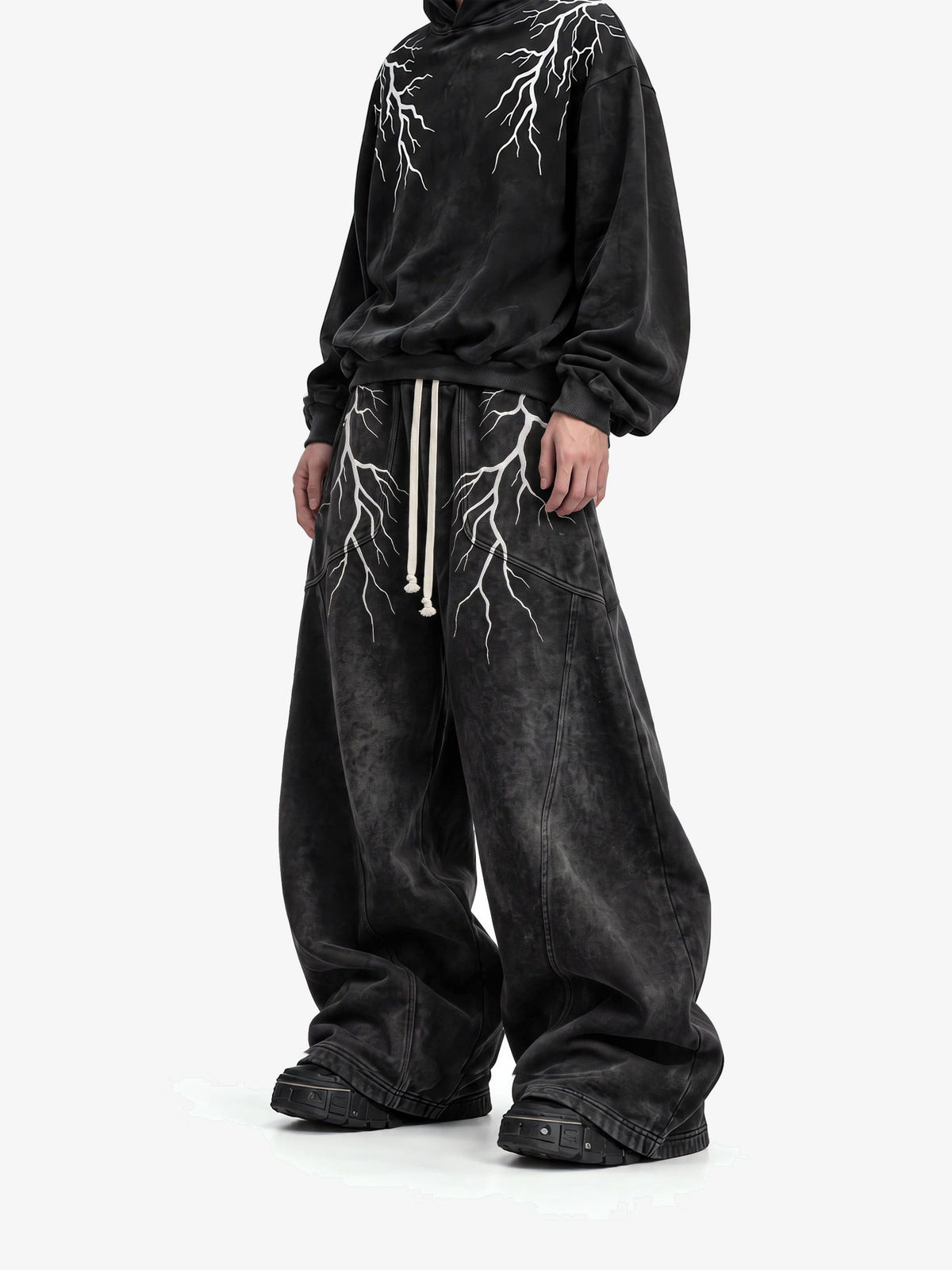Acid Wash Black Lightning Print Sweatpants – On model, front (with matching hoodie) | XoKool