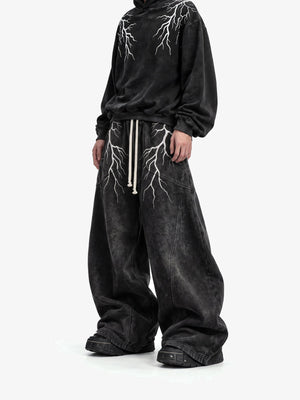 Acid Wash Black Lightning Print Sweatpants – On model, front (with matching hoodie) | XoKool