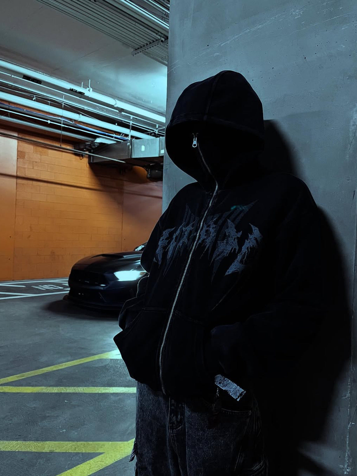 Ski mask hoodie – on model, parking garage | XoKool