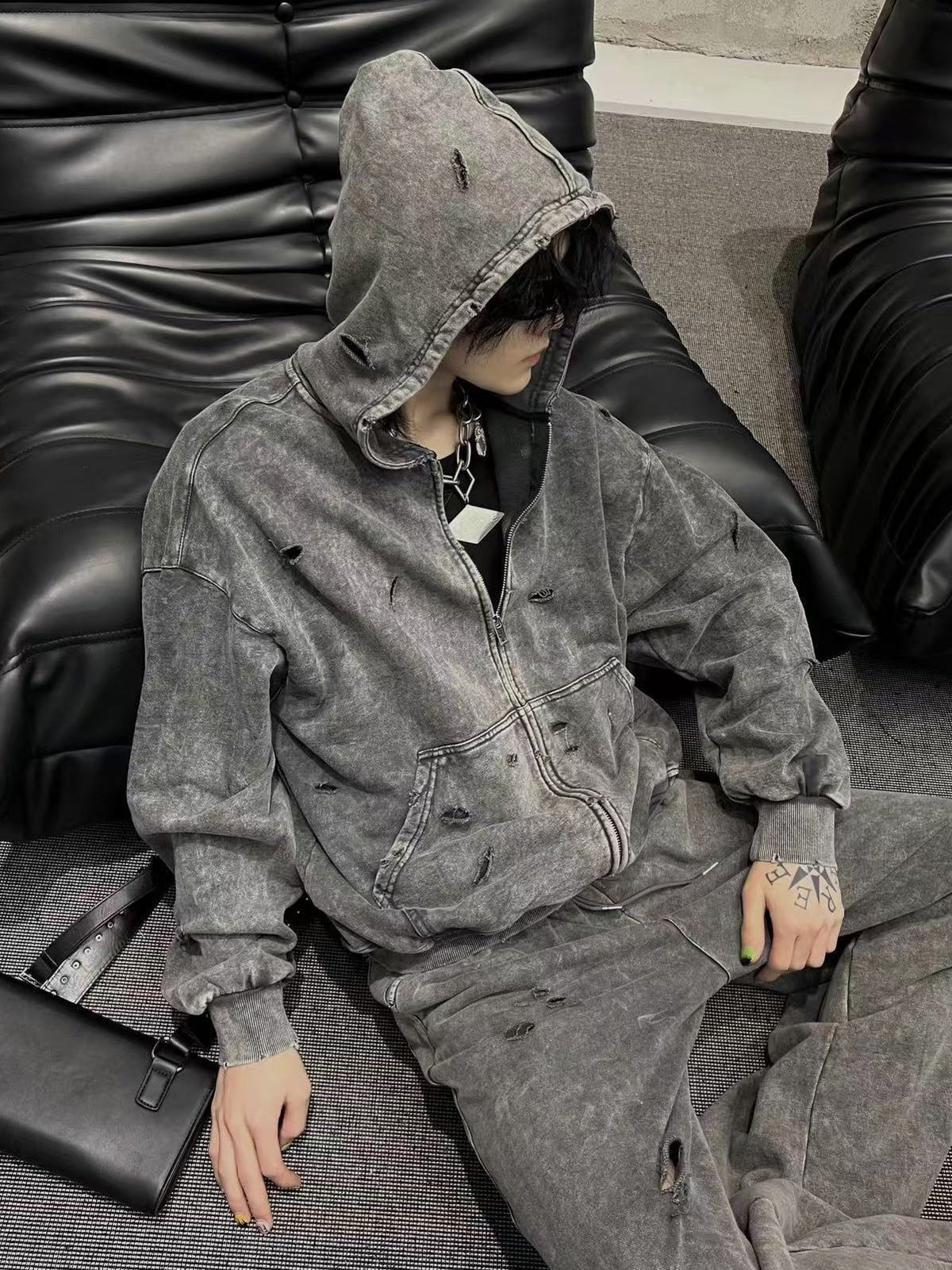 Acid wash zip up hoodie – on model, sitting | XoKool