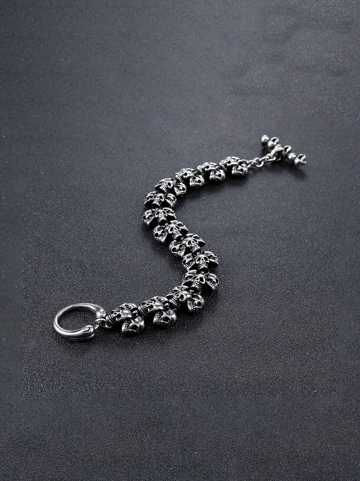Antiqued Skull Link Biker Bracelet – laid open flat on dark surface | XoKool