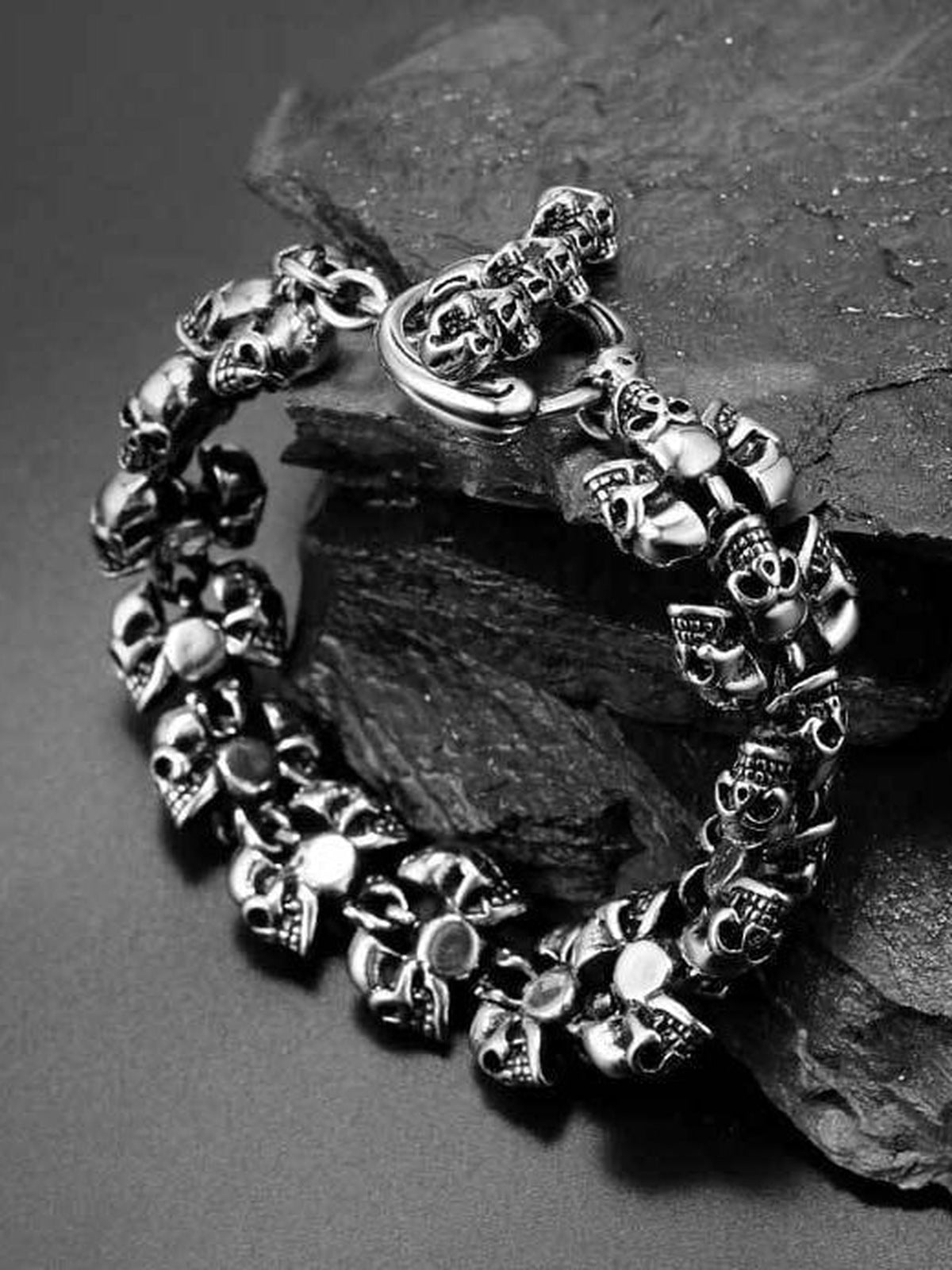 Antiqued Skull Link Biker Bracelet – on dark stone, close-up | XoKool
