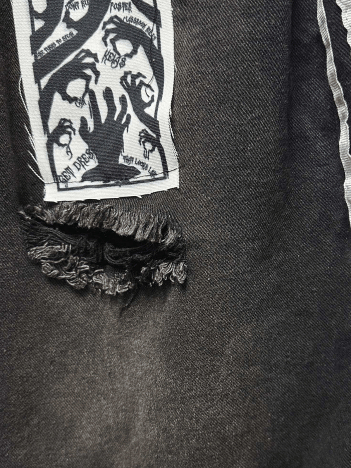 Black jorts – patch and rip close-up | XoKool