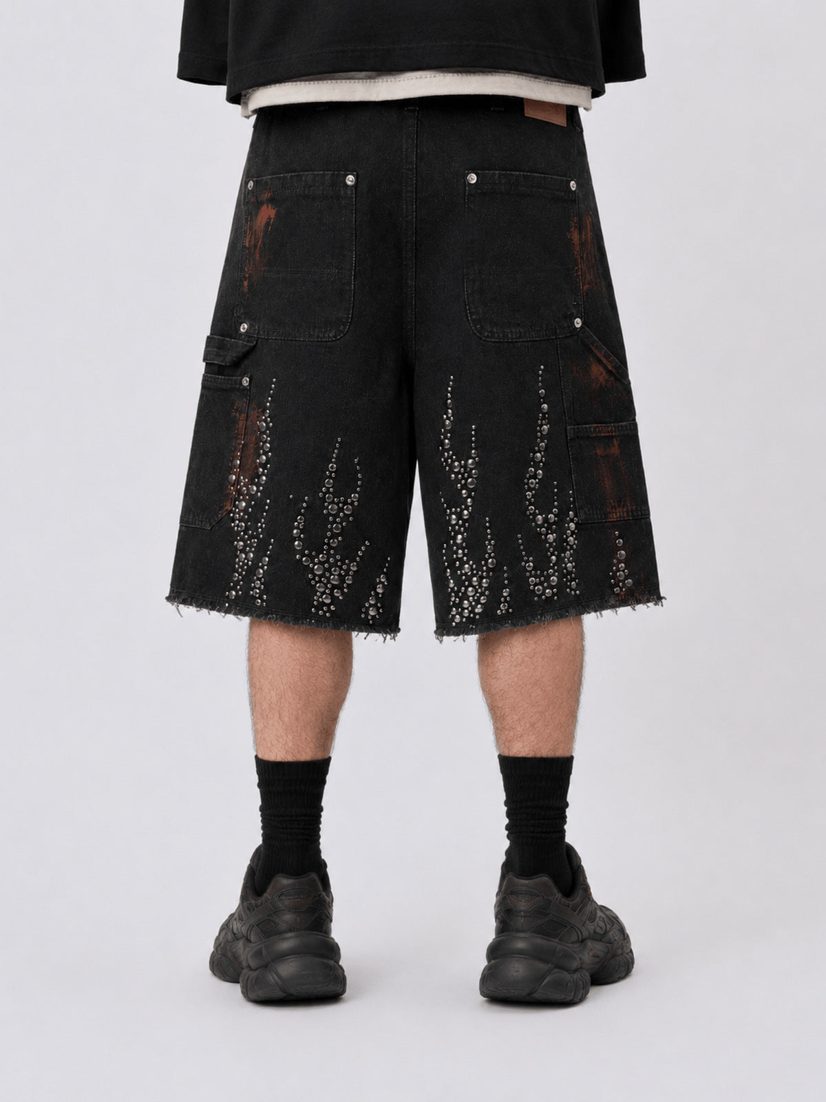 Studded flame jorts – on model, back lower | XoKool
