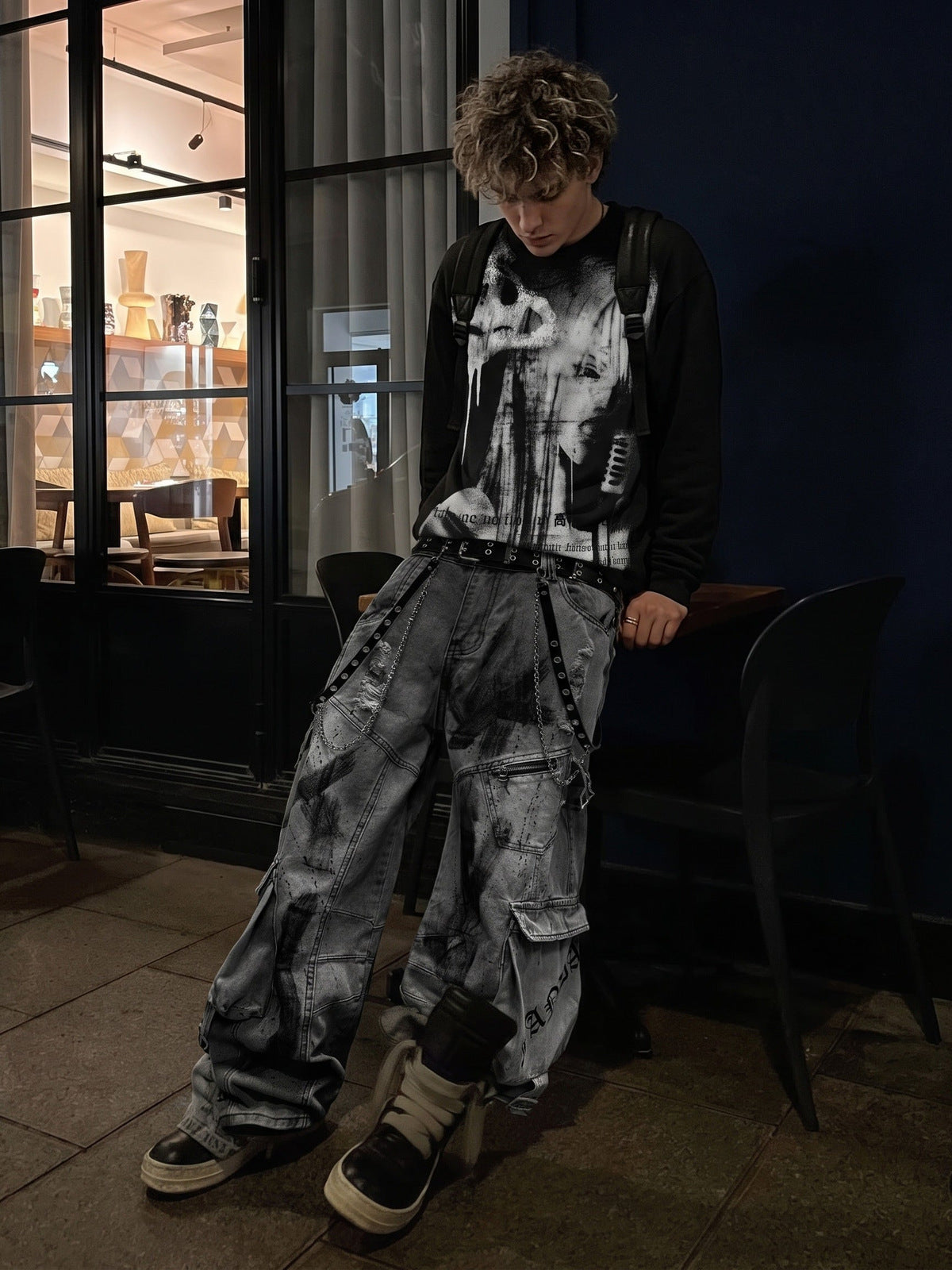 Black Long Sleeve Graphic Shirt with Paint Drip Print – on model, street at night | XoKool
