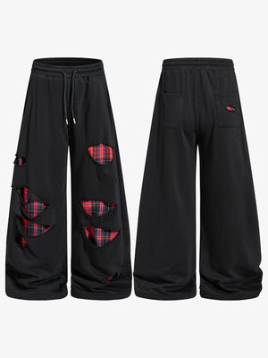 Schwarze Ripped Jogginghose mit Karo-Patches – Vorder- und Rückansicht | XoKool