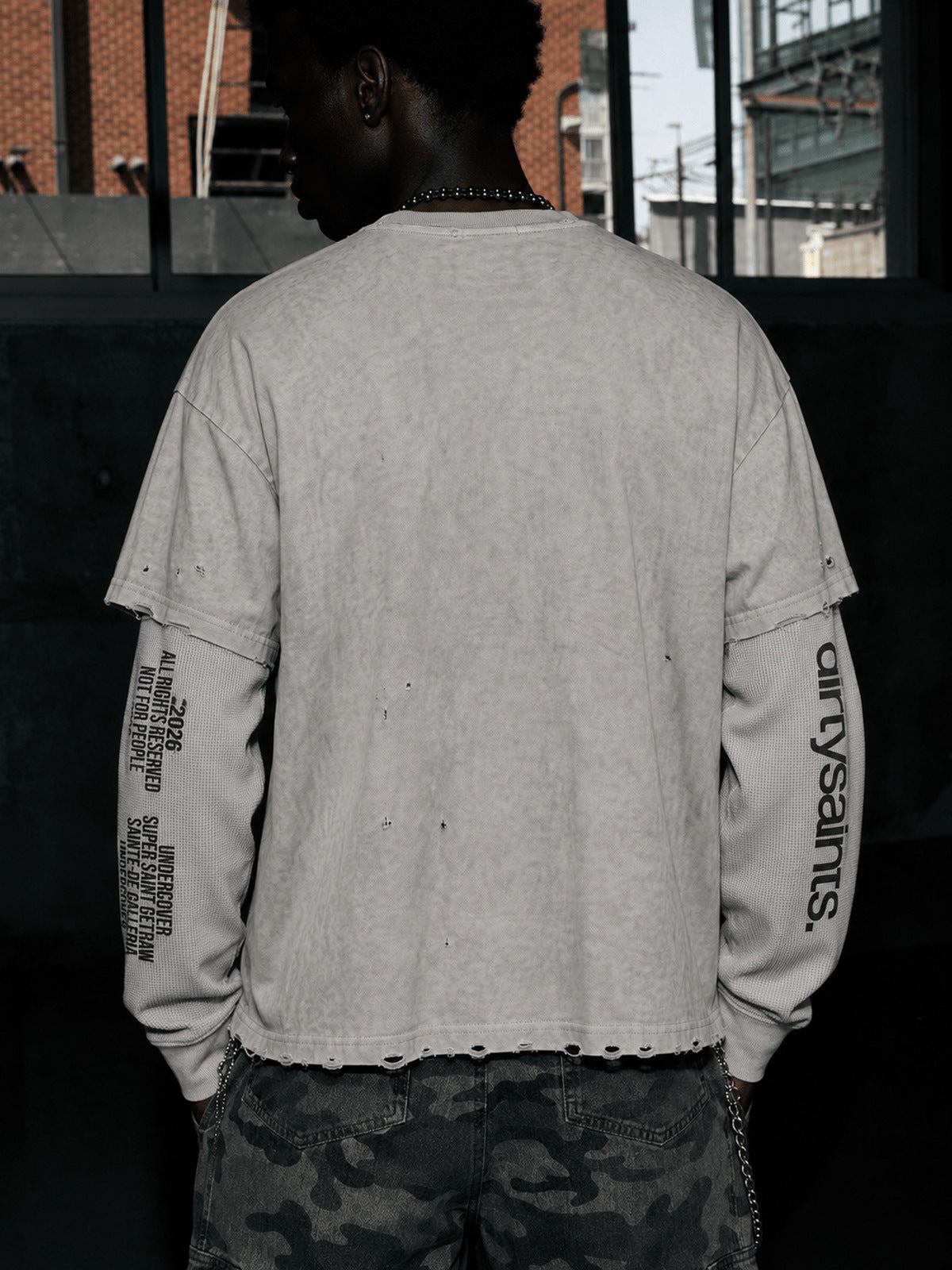Distressed Layered Long Sleeve Shirt with Text Print – On model, back | XoKool