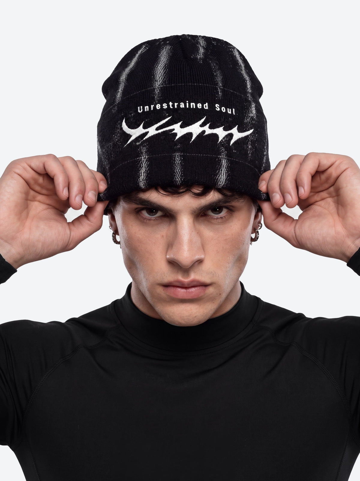 Thorn embroidered beanie – on model (man), front pulling on | XoKool