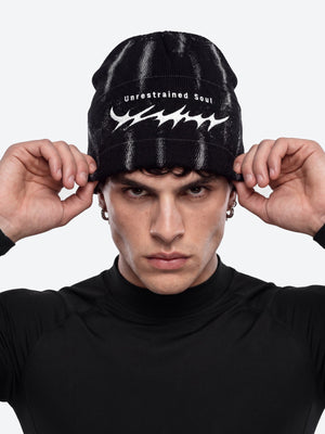Thorn embroidered beanie – on model (man), front pulling on | XoKool