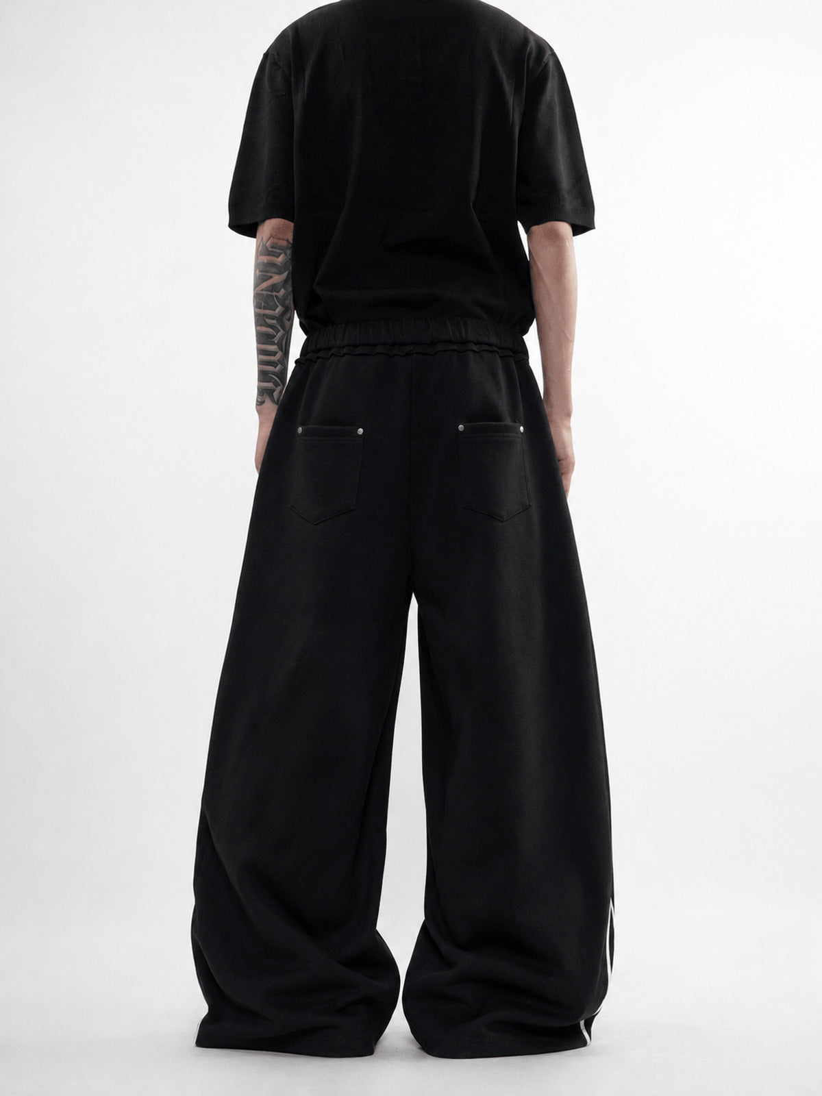 Faded Baggy Sweatpants with Contrast Piping – Black, on model back | XoKool