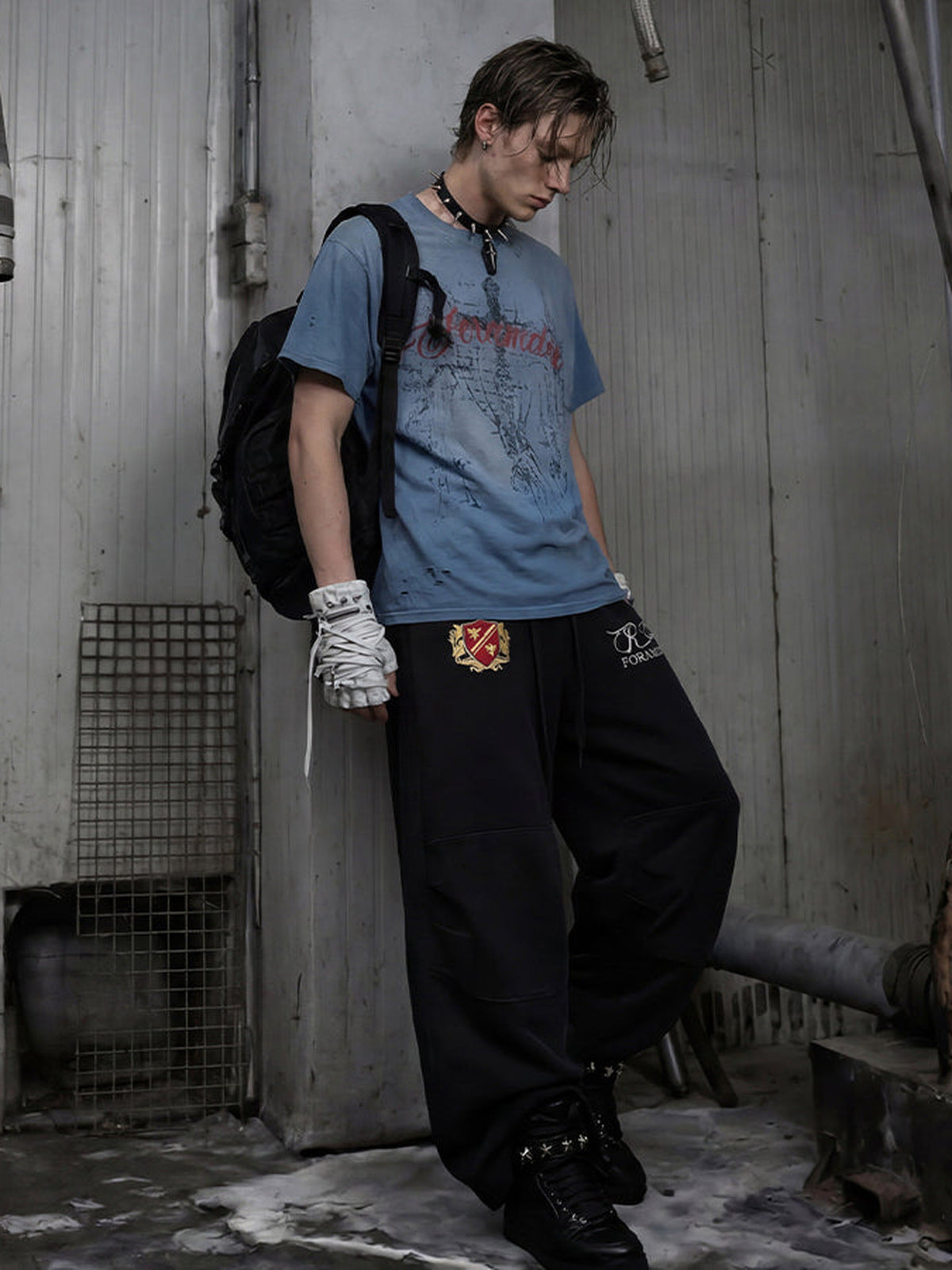 Embroidered sweatpants – Black, on model leaning | XoKool