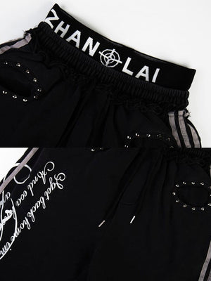 Pantalones deportivos con tachuelas – Detalle del emblema en la cintura y las tachuelas, negro | XoKool