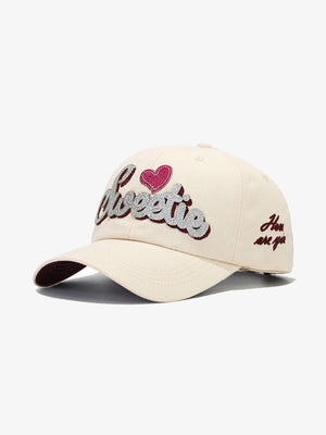 Heart Embroidered Baseball Cap with Script Lettering – Cream, three-quarter front view | XoKool
