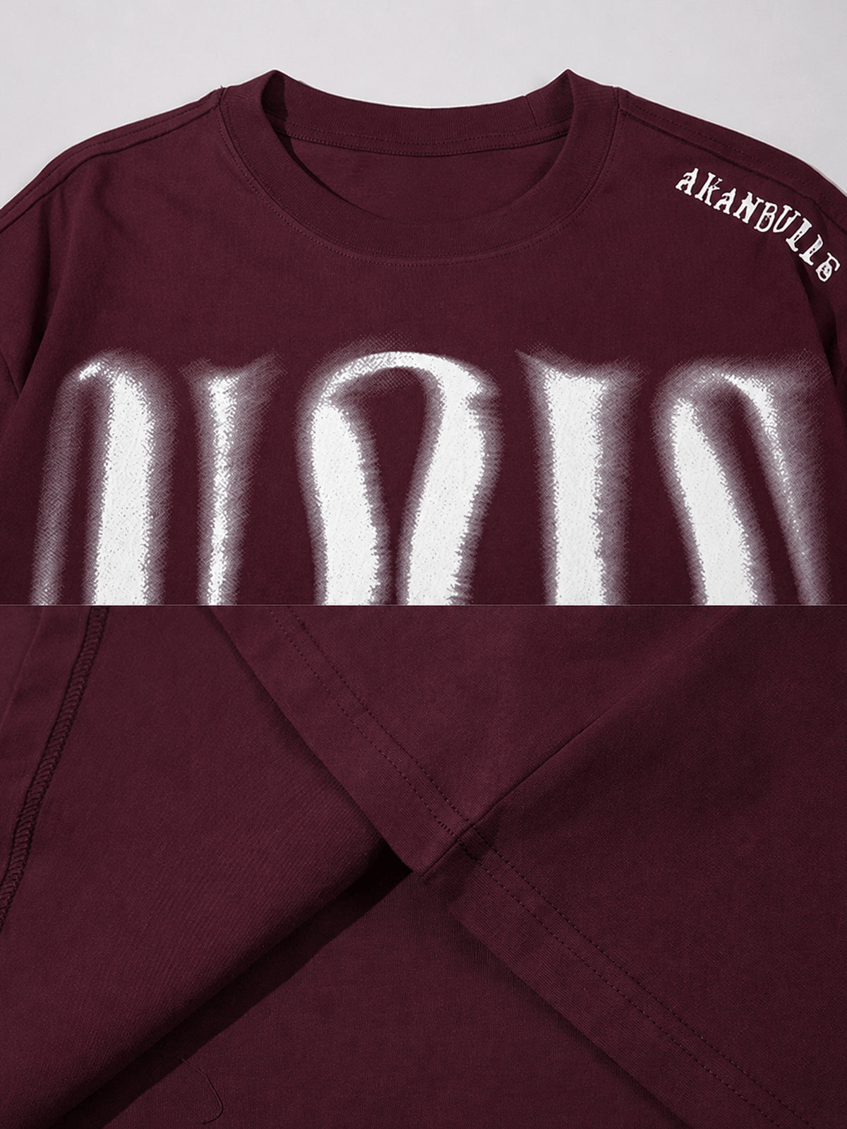 Blurred letter oversized tee – Burgundy collar and shoulder text close-up | XoKool